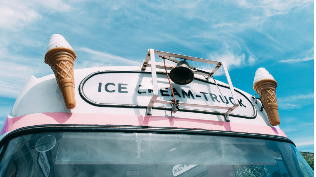 Six Swirls ice cream truck parked at a corporate event in Canada, decorated in bright colors with a playful design and open service window.